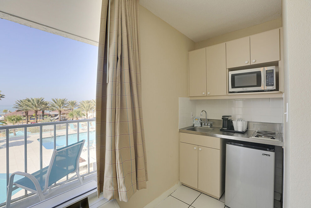 a kitchen with a view of a pool and a window
