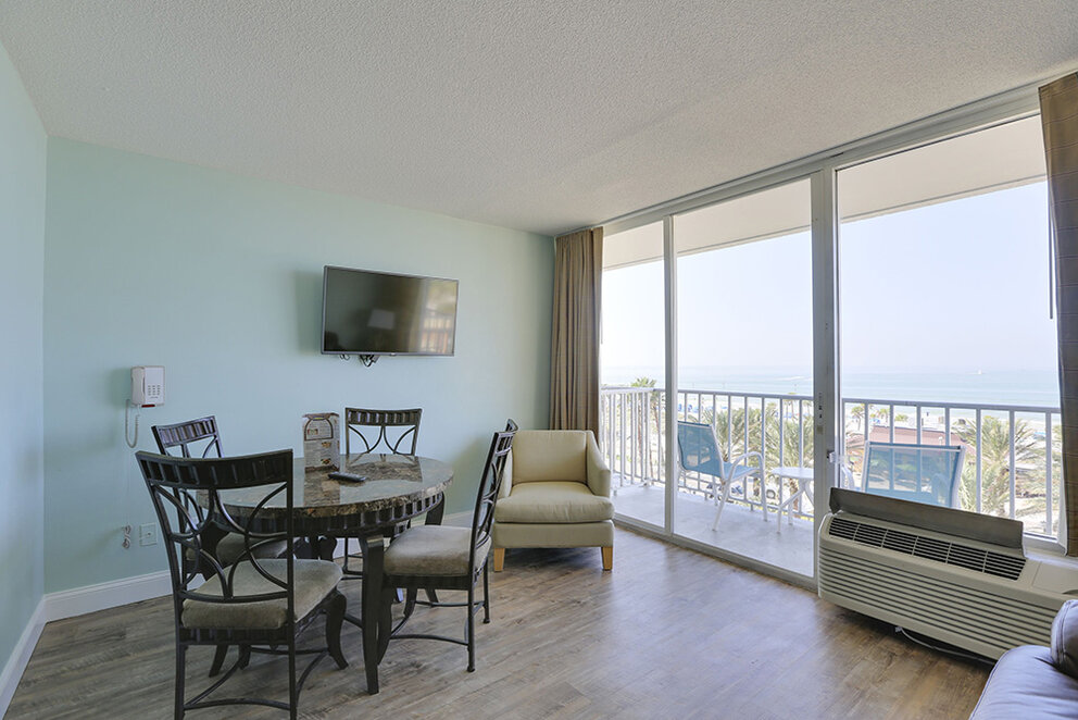 a room with a table and chairs and a television