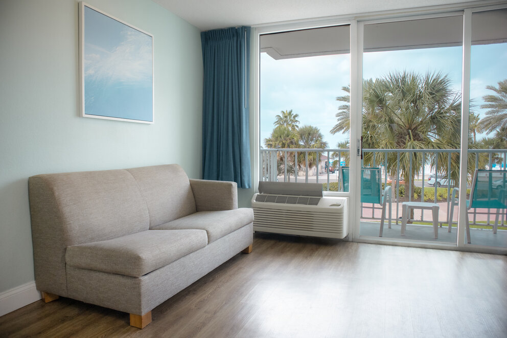 a couch in a room with a heater and a balcony